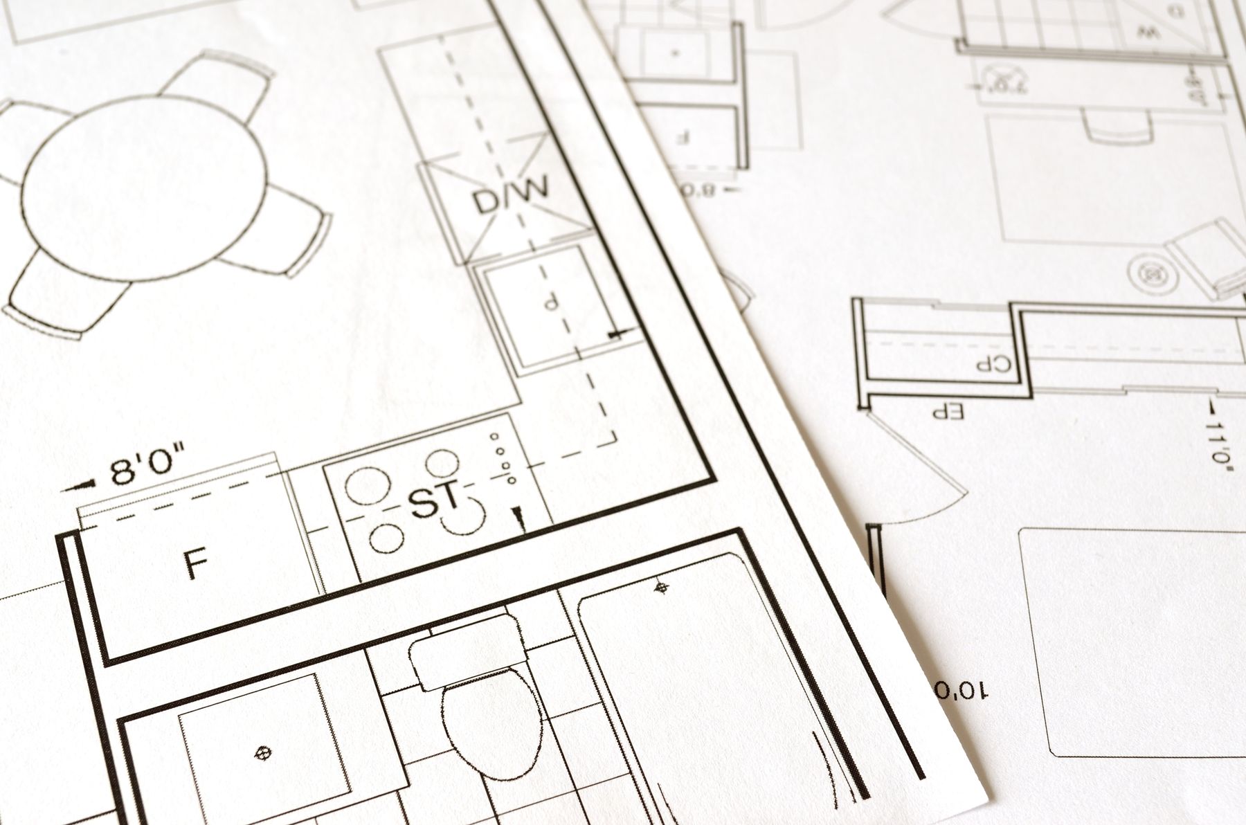 Residential floor plans spread across a table
